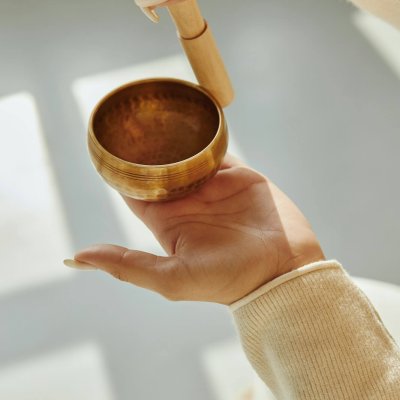 closeup of woman hands using singing bowl in sound healing therapy .jpg